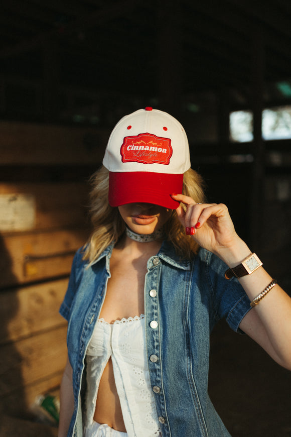 Cinnamon Lifestyle red and tan hat.